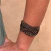 Brazalete entrelazado negro y dorado