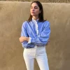 Camisa celeste rayas volante troquelado